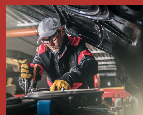 Automotive Tradesperson Installing Clamp On Car Automotive Tradesperson Installing Clamp On Car